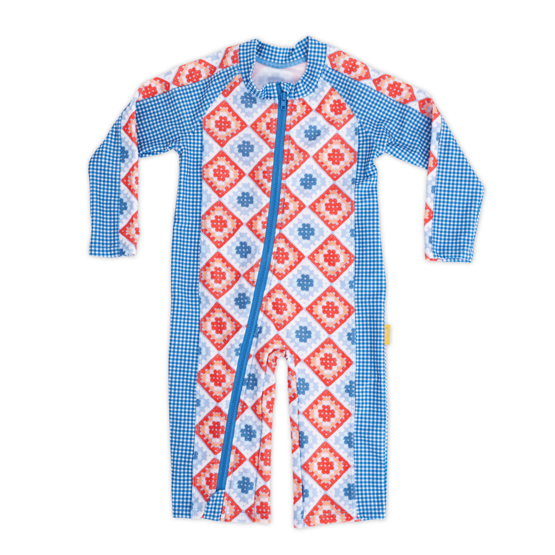 Baby long sleeve sunsuit in Modern Retro Granny Square print, full-length legs and sleeves, UPF 50+ sun protection, with contrast blue front zip and raglan sleeves – eco-friendly recycled polyester swimwear.