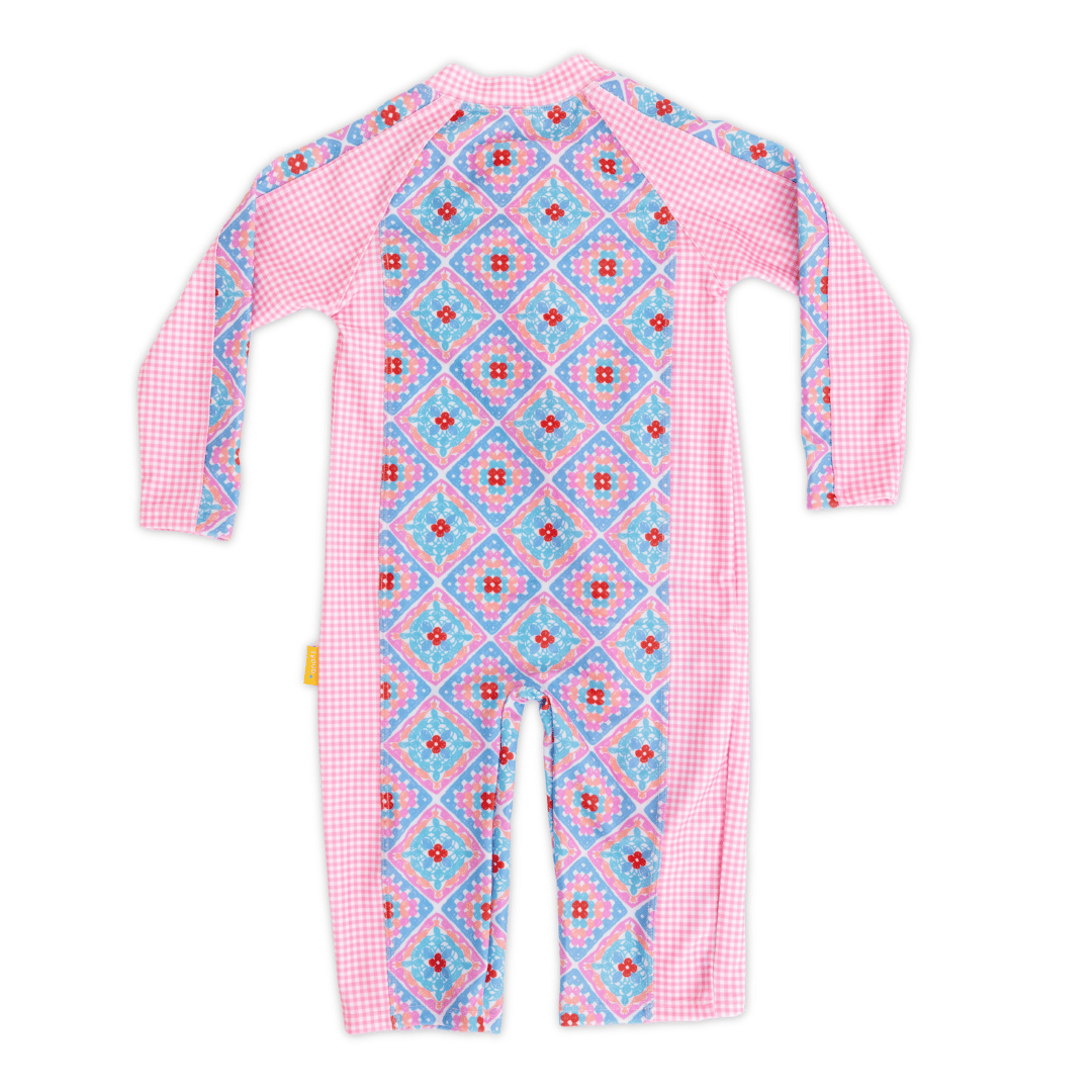 Back view of Baby long sleeve sunsuit in Petal Patchwork crochet print with pink gingham sleeves, full-body sun coverage, flatlock seam finish, ankle closure, crafted from eco-friendly recycled polyester fabric.