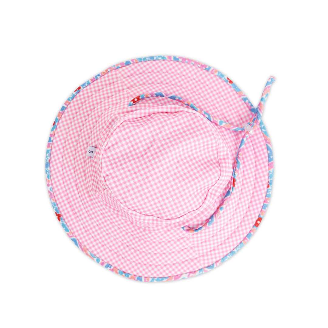 Inside view of Tyoub kids’ ruffle sun hat, showing pink gingham reverse check lining, chin strap with pull-closure, neat stitching and quality finish, crafted from sustainable recycled polyester fabric.