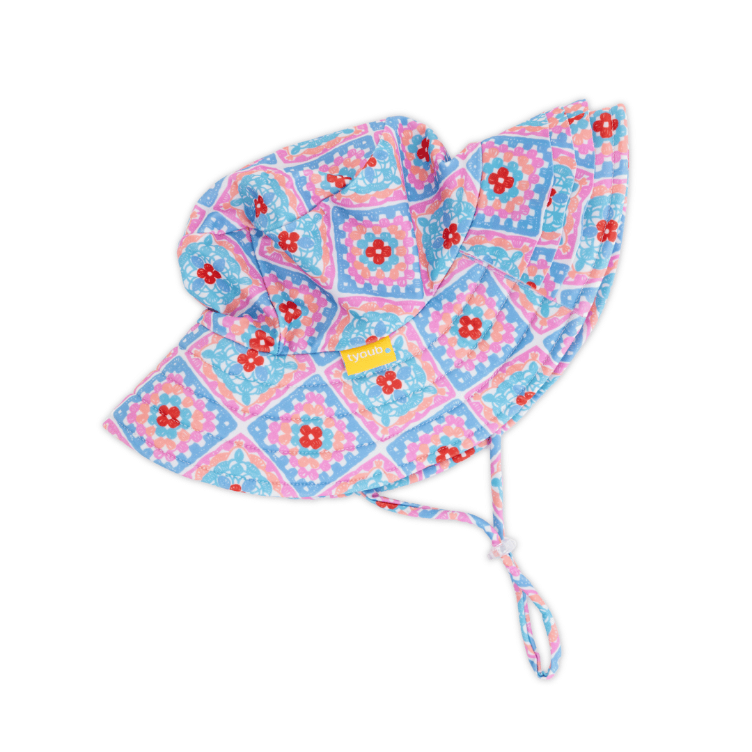 Side view of Tyoub kids’ ruffle sun hat in Petal Patchwork print, broad brim with layered ruffles, foam shape-retention brim and adjustable chin strap, eco-friendly recycled swim fabric.