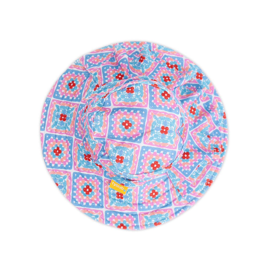 Tyoub kids’ ruffle sun hat in Petal Patchwork crochet print with three-tiered flounce brim, wide coverage design made from recycled polyester swim fabric, UPF 50+ sun protection.”