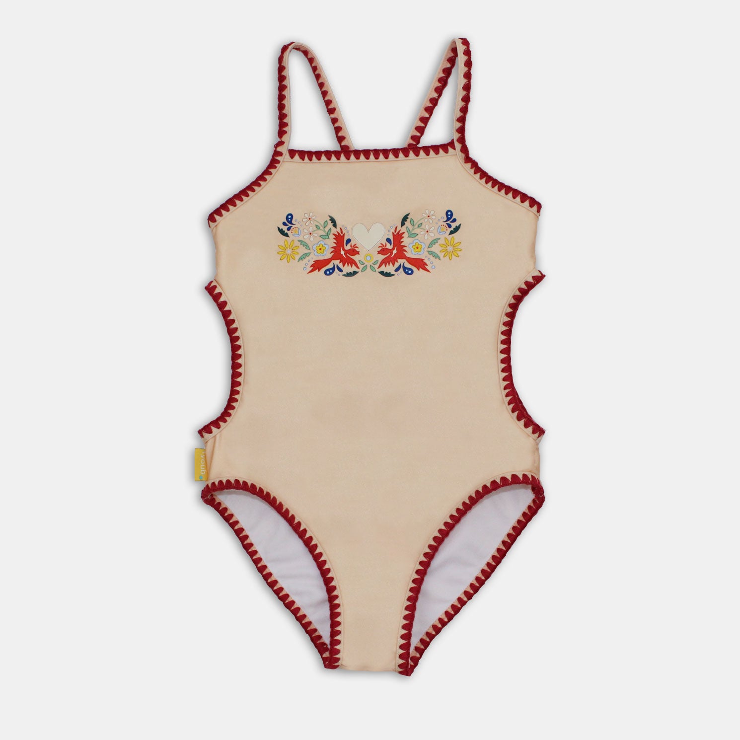 Girl’s cut-out swimsuit, one piece with decorative heart print on front. Embroidered stitching on edges and straps. Made from recycled polyester. UPF 50+ sun protection and fully lined.