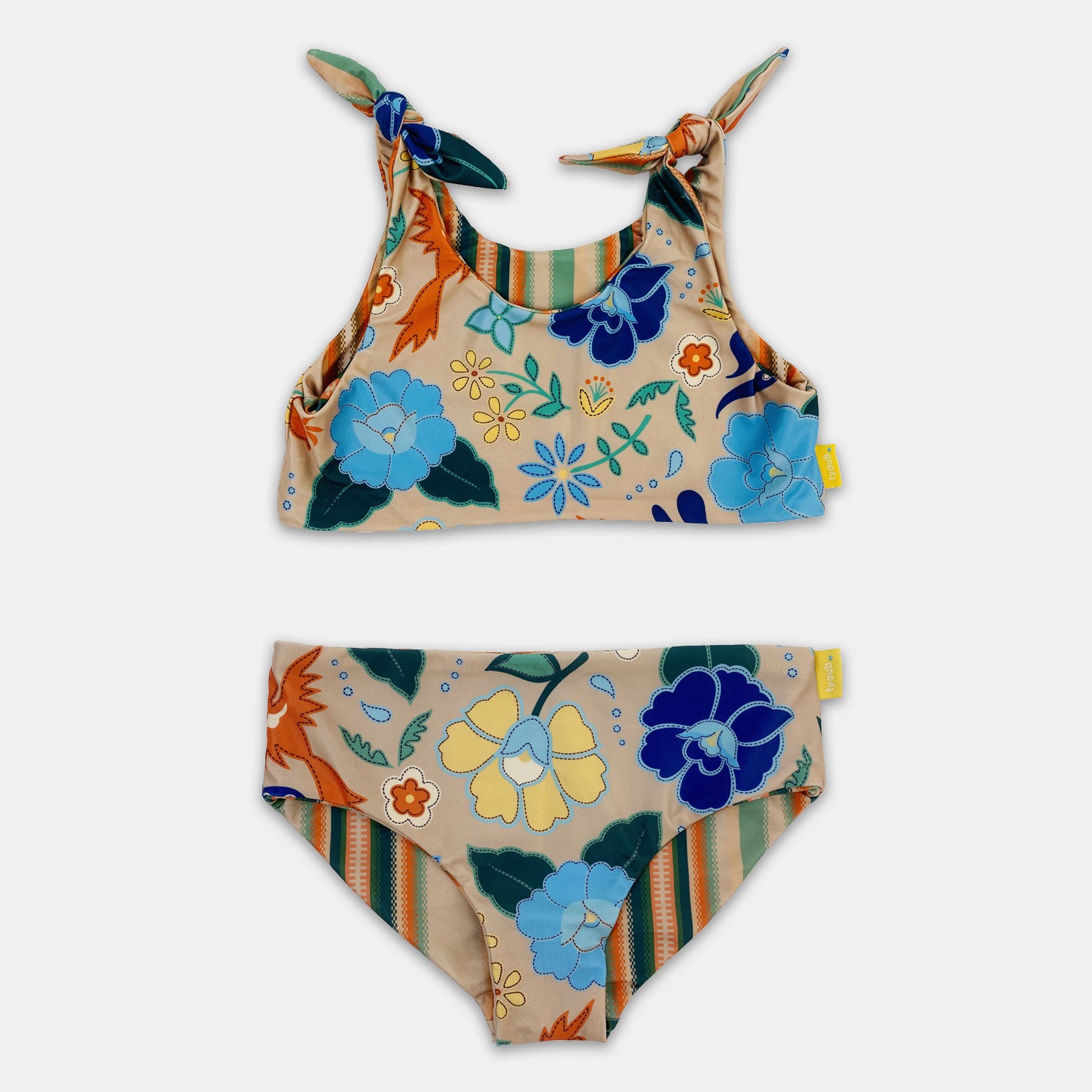 Two piece reversible bikini. Crop top style with bow ties on the shoulder straps, classic fit bikini brief. Super comfortable and secure style. Side 1 is a floral bird print and side 2 is a brown, orange and cream serape stripe. Can be worn on both sides or mixed and matched as you like.
